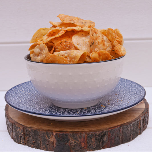Bowl of masala papdi on a decorative plate with a wooden stand